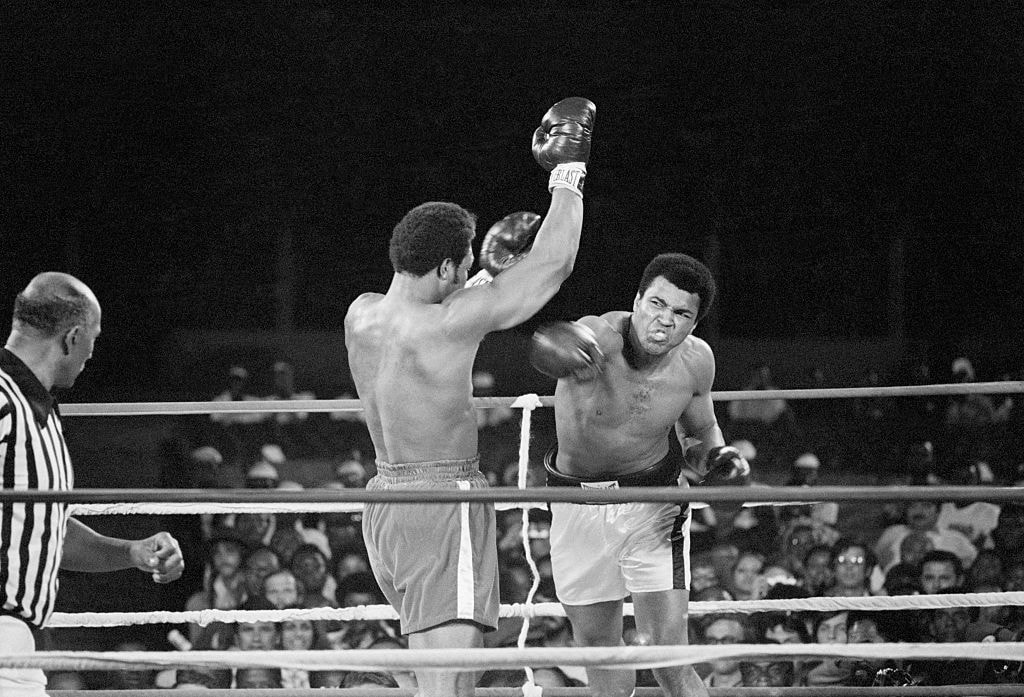 Muhammad Ali punches George Foreman during their world heavyweight title boxing match in 1974.