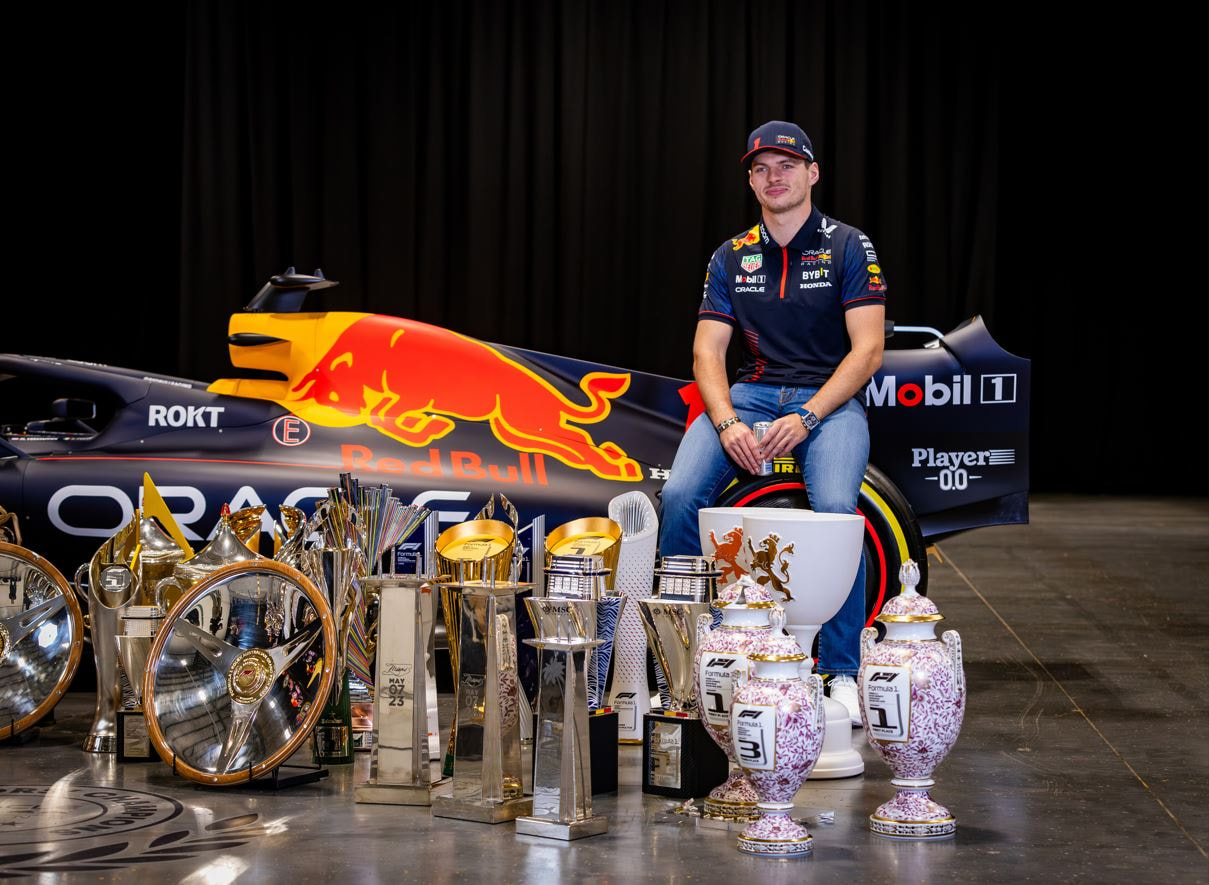 Max Verstappen poses in front of his Red Bull team’s 2023 trophy haul.