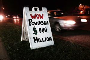 A makeshift roadside sign announced a $900 million Powerball lottery prize.