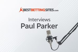 The image shows the logo of "BestBettingSites.com" at the top, followed by the text "Interviews Lee Sharpe" in the center. To the right, there's a professional microphone set up, suggesting that the image is promoting an interview, likely with former footballer Paul Parker. The overall design is clean and minimalist, featuring light grey diagonal lines in the background.