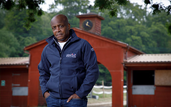 Paul Parker, the ex England footballer, who played for Fulham, QPR and Manchester United, poses for a portrait at the yard of racehorse trainer