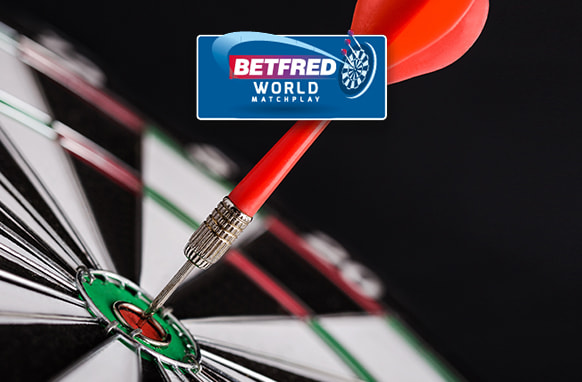 The image shows a close-up of a dartboard with a dart precisely hitting the bullseye. Above this scene is the logo for Betfred World Matchplay, suggesting a context related to a darts competition. The image captures the precision and skill associated with the sport.