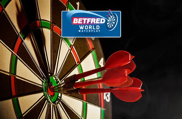 The image showcases a dartboard with several red darts perfectly embedded in the bullseye. Above the dartboard is the Betfred World Matchplay logo, indicating a connection to a prestigious darts tournament. The scene emphasises the skill and precision involved in achieving a perfect shot in darts.