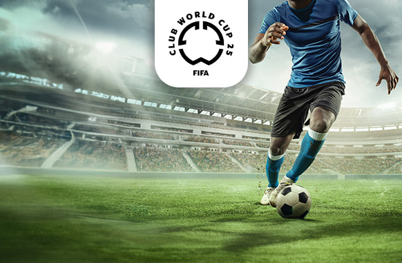 The image features a football player in a blue shirt and shorts controlling a football on a grass field within a large stadium. The stadium's architecture is visible, with empty stands in the background. Above the player, the FIFA Club World Cup 2025 logo is centrally positioned. The setting conveys a sense of focus and action on the field.
