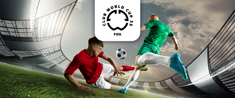 The image captures an intense football moment inside a stadium. Two players are engaged in a dynamic play, one wearing a red shirt and executing a sliding tackle, while the other player in a green shirt evades the challenge. A football is prominently visible between them as they compete. Above the scene is the logo for the FIFA Club World Cup 2025, positioned centrally. The curved architecture of the stadium adds to the dramatic atmosphere.