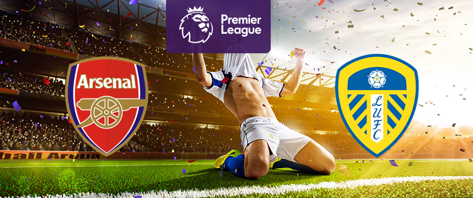 The image shows the logos of two Premier League football clubs, Arsenal and Leeds United, displayed in front of a jubilant football player who is sliding on his knees in celebration. The Arsenal logo is on the left side, featuring a red shield with a cannon and the text "Arsenal." The Leeds United logo is on the right side, featuring a shield with yellow and blue stripes, a white rose at the top, and the text "LUFC." In the centre, there is the Premier League logo, consisting of a lion's head above the text "Premier League." The background depicts a stadium filled with cheering fans and confetti raining down, creating a celebratory atmosphere.