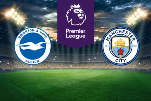 The image shows the logos of two Premier League football clubs, Brighton & Hove Albion and Manchester City, displayed on a football pitch background. The Brighton & Hove Albion logo is on the left side, featuring a white seagull in flight on a blue circle with a white border containing the text 