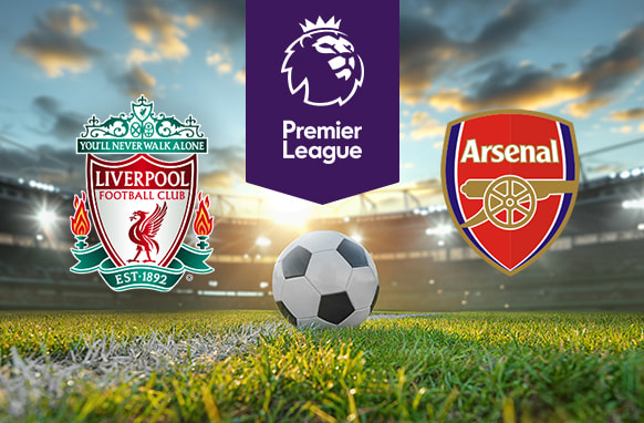 The image shows the logos of two Premier League football clubs, Liverpool and Arsenal, displayed on a football pitch background with a football placed at the centre. The Liverpool logo is on the left side, featuring a traditional crest design with elements such as the Liver bird and the text "Liverpool Football Club" along with "You'll Never Walk Alone" incorporated above, and "Est. 1892" in a banner below. The Arsenal logo is on the right side, featuring a red shield with a gold cannon and the text "Arsenal" above it. In the centre, above the football, there is the Premier League logo, consisting of a lion's head above the text "Premier League." The background depicts a football stadium with a dramatic sky during either sunrise or sunset, creating a dynamic and compelling atmosphere.
