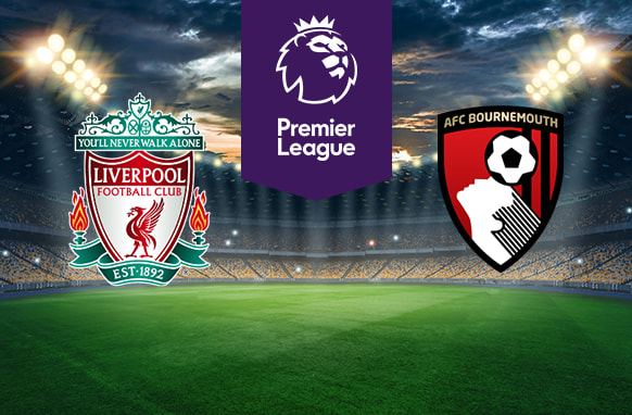 The image shows the logos of two Premier League football clubs, Liverpool FC and AFC Bournemouth, displayed on a football field background. The Liverpool FC logo is on the left side, featuring a red liver bird and the text "You'll Never Walk Alone," with the club established in 1892. The AFC Bournemouth logo is on the right side, featuring a stylized player heading a football. In the centre, there is the Premier League logo, consisting of a lion's head above the text "Premier League." The background depicts a lit football stadium with a dramatic, cloudy sky above.