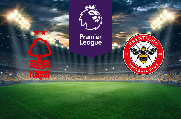 The image shows the logos of two Premier League football clubs, Nottingham Forest and Brentford, displayed on a football pitch background. The Nottingham Forest logo is on the left side, featuring a stylised tree with two stars above it and wavy lines below, along with the text "Forest." The Brentford logo is on the right side, featuring a bee and the text "Brentford Football Club" and "1889." In the centre, there is the Premier League logo, consisting of a lion's head above the text "Premier League." The background depicts a lit football stadium with a dramatic, cloudy sky above.