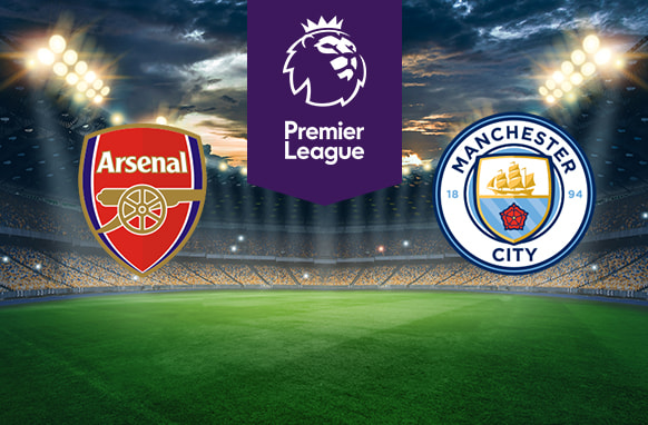 An illuminated football stadium backdrop. In the centre, a purple Premier League logo. On the left, the Arsenal Football Club emblem. On the right, the Manchester City Football Club emblem.