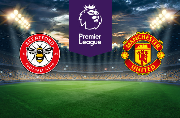 The image shows the logos of two football clubs, Brentford and Manchester United, displayed on a football pitch. The Brentford logo is on the left, featuring a red and white circular design with a bee in the centre and the text "Brentford Football Club" along with the years "18" and "89." The Manchester United logo is on the right, featuring a red and yellow crest with a ship and a devil, and the text "Manchester United" around it. In the centre above the pitch is the Premier League logo, which includes a lion's head and the text "Premier League" below it on a purple background. The background depicts a stadium with dramatic lighting, creating an intense and vibrant atmosphere.