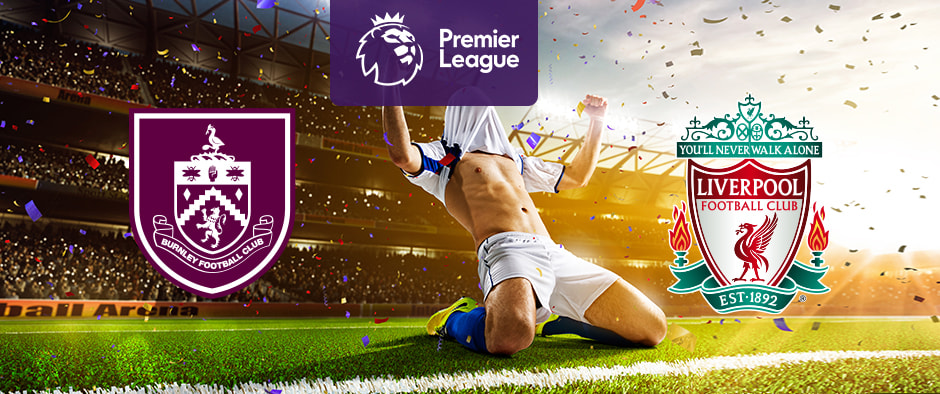 The image shows the logos of two football clubs, Burnley and Liverpool, displayed in front of a football player who is celebrating by sliding on the pitch. The Burnley logo is on the left, featuring a maroon and white crest with various symbols and the text "Burnley Football Club." The Liverpool logo is on the right, featuring a green, red, and white crest with a liver bird and the text "Liverpool Football Club," along with the motto "You'll Never Walk Alone" and the establishment year "EST 1892." In the centre above the celebrating player is the Premier League logo, which includes a lion's head and the text "Premier League" below it on a purple background. The background depicts a stadium filled with cheering fans and confetti, creating a dynamic and exhilarating atmosphere.