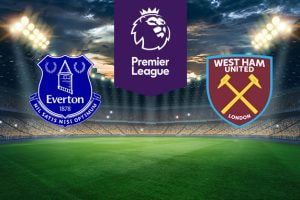 The image shows the logos of two football clubs, Everton and West Ham United, displayed on a football pitch. The Everton logo is on the left, featuring a blue shield with the Prince Rupert's Tower in the centre, flanked by laurel wreaths with the text