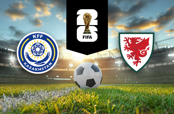 The image shows the logos of two national football associations, the Kazakhstan Football Federation and the Football Association of Wales, displayed on a football pitch with a football in the centre. The Kazakhstan logo is on the left, featuring a blue and yellow circular design with the text "KFF Kazakhstan." The Wales logo is on the right, featuring a red dragon on a shield. In the centre above the football is the FIFA logo, which includes the FIFA World Cup Trophy and "FIFA" below it on a black background. The setting is a stadium with dramatic sky lighting, giving it a dynamic and intense atmosphere.