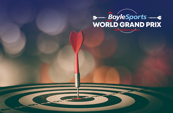 The image features a dart sticking precisely into the bullseye of a dartboard, representing a perfect shot. Above the dartboard, the text "BoyleSports World Grand Prix" is displayed, with a logo of two small darts incorporated into the design. The background is blurred, creating a bokeh effect with soft light circles, adding depth and a sense of focus on the central elements of the dart and the dartboard. The overall atmosphere is one of precision and achievement, highlighting the significance of the event.