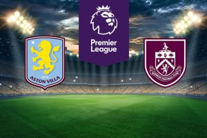 The image shows the logos of two football clubs, Aston Villa and Burnley, displayed on a football pitch. The Aston Villa logo is on the left, featuring a yellow lion on a light blue shield with the text