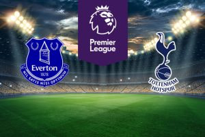 The image features two Premier League football team logos on a football pitch. On the left is Everton's logo, which is designed in blue and white and includes a tower, two laurel wreaths, and the club's motto "Nil Satis Nisi Optimum" (Nothing but the best is good enough). It also includes the club's name and year of establishment (1878). On the right is Tottenham Hotspur's logo, which features a cockerel standing on a football. The logo includes the club's name below it. Above the logos in the centre is the Premier League logo with a stylised lion's head and the words "Premier League" on a purple background. The background shows a stadium with bright lights and a dramatic sky, creating an atmosphere of anticipation and excitement.