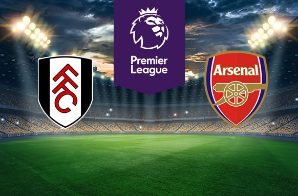 The image features two Premier League football team logos on a football pitch. On the left is Fulham's logo, with the letters "FFC" in black and red on a white shield. On the right is Arsenal's logo, featuring a cannon and the word "Arsenal" on a red and gold shield. In the centre is the Premier League logo with a stylised lion's head and the words "Premier League" on a purple stripe. The background shows a stadium with bright lights and a dramatic sky, creating an atmosphere of anticipation and excitement.