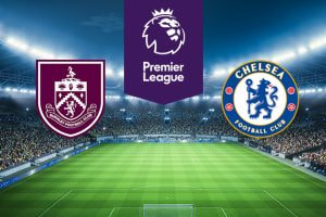 The image features logos representing two football clubs participating in a Premier League match. On the left is the logo of Burnley Football Club, which includes a shield with various symbols and a claret and blue colour scheme. On the right is the logo of Chelsea Football Club, featuring a blue lion holding a staff with red roses and footballs around the edge. Above the logos is the Premier League logo, featuring a lion's head with a crown and the text 