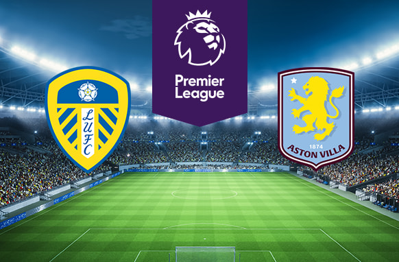 The image features logos representing two football clubs participating in a Premier League match. On the left is the logo of Leeds United, featuring a white rose and the initials "LUFC" over a shield. On the right is the logo of Aston Villa, which includes a lion and a star with the club's name and founding year. Above the logos is the Premier League logo, depicting a crowned lion's head with the text "Premier League" beneath it. The background shows a brightly lit stadium filled with spectators, creating an atmosphere of anticipation and excitement for the upcoming match.