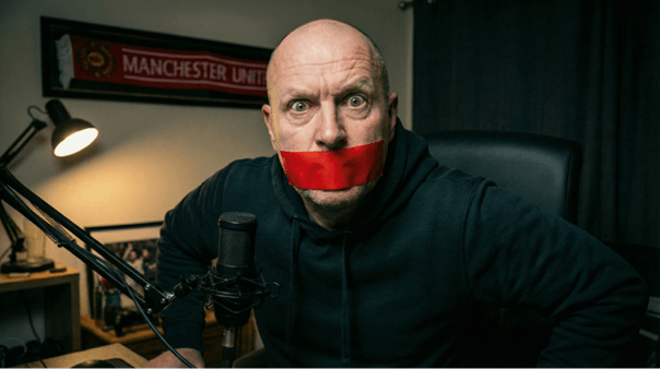 A fan podcaster with tape over his mouth symbolising being silenced.